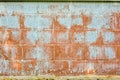 Texture of red fluted brick wall with white peeling paint