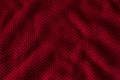 Texture of red knitted sweater closeup, burgundy background
