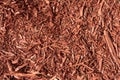 Red Mulch.Texture of pieces of tree bark.Gardening and park work. Royalty Free Stock Photo