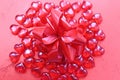 Texture red plastic hearts with a red bow Royalty Free Stock Photo