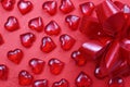 Texture red plastic hearts with a red bow Royalty Free Stock Photo