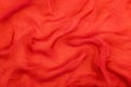 Texture of the red soft chiffon fabric with folds. Closeup of rippled red silk fabric Royalty Free Stock Photo