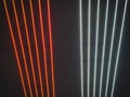 Texture of red and white glowing bright neon LED multicolored laser abstract stripes and lines from parallel lamps. The background Royalty Free Stock Photo