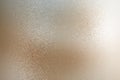 Texture of reflection on rough light brown metallic wall, abstract background