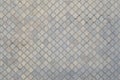 The texture of a rhythmic mosaic made of concrete tiles. Background image of a large area of old and damaged gray tile Royalty Free Stock Photo