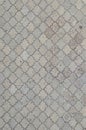 The texture of a rhythmic mosaic made of concrete tiles. Background image of a large area of old and damaged gray tile Royalty Free Stock Photo