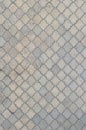 The texture of a rhythmic mosaic made of concrete tiles. Background image of a large area of old and damaged gray tile Royalty Free Stock Photo