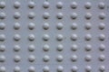 Texture of rivets massive metal construction. Attachment of the metal part of the bridge white painted. Array of convex white