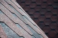 The texture of the roof with bituminous coating. Rough bituminous mosaic of red and brown flowers. Waterproof roofin Royalty Free Stock Photo