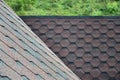 The texture of the roof with bituminous coating. Rough bituminous mosaic of red and brown flowers. Waterproof roofin Royalty Free Stock Photo