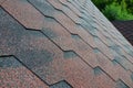 The texture of the roof with bituminous coating. Rough bituminous mosaic of red and brown flowers. Waterproof roofin Royalty Free Stock Photo