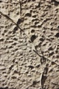 Texture rough brown gray surface of an old cement wall with cracks, patterns and divorces Royalty Free Stock Photo