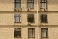 Texture of a row of windows on a brown brick wall Royalty Free Stock Photo