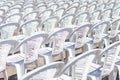 Rows of white plastic concert chairs, selective focus. Royalty Free Stock Photo