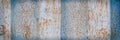 The texture of rusted metal painted in blue. Rough metal surface with rust. Royalty Free Stock Photo
