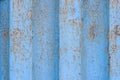 The texture of rusted metal painted in blue. Rough metal surface with rust. Royalty Free Stock Photo