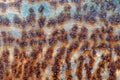 Texture of rusty iron sheet with holes. Metal corrosion. Damaged metal. Rusty iron surface