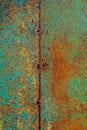 Texture of rusty metal, painted green which becames orange from rust. Vertical texture of cracked paint on rusty welded steel Royalty Free Stock Photo