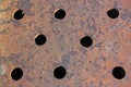 Texture of a rusty metal sheet with holes close-up Royalty Free Stock Photo