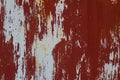 The texture is a rusty metallic orange painted surface with paint cracks and rust spots. background Royalty Free Stock Photo