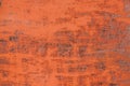 The texture is a rusty metallic orange painted surface with paint cracks and rust spots. background Royalty Free Stock Photo