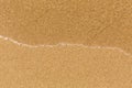 Texture sand beach with soft waves. Sea. Royalty Free Stock Photo