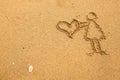In texture of sand: girl holding a big heart. Love. Royalty Free Stock Photo