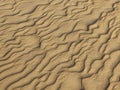 Texture of sand waves on the beach or in the desert. the ripples of the sand is diagonal. Royalty Free Stock Photo