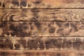 The texture of the scorched wooden wall. Wall of smooth orange long wooden boards with a specific black texture of fryin