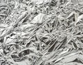 Texture of shiny crumpled piece of gray foil, packaging material for food and objects