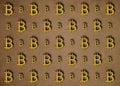 Texture of sign crypto currency of bitcoin on gold background. Symbol BTC.