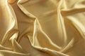 Texture of smooth luxury elegant golden silk fabric as background.