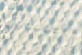 The texture of the snow in the cells. Background, a grid covered with a thick layer of snow.