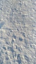 The texture of the snow cover in winter with traces