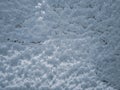 Texture of snow-white snowflakes on the surface. Beautiful frosty snow pattern on the window. Winter Wallpaper with frosty Royalty Free Stock Photo