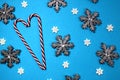 Texture of snowflakes big and small on a blue background with a cane in the form of a heart