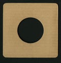 Texture - a square segment of brown corrugated cardboard with a round hole in the center Royalty Free Stock Photo