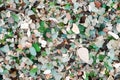 The texture of a stone beach with many pieces of colored glass turned by water Royalty Free Stock Photo