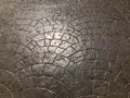 Texture of stone concrete road beautiful solid strong tile shiny natural from bricks with patterned seams and cracks. The backgrou