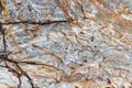 Texture of stone or marble with brown streaks with deep cracks on the left side