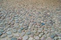 The texture of the stone road, pavement, walls of large gray old medieval round strong stones, cobblestones. The background Royalty Free Stock Photo