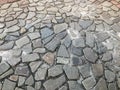 The texture of the stone road, pavement, walls of large gray old medieval round strong stones, cobblestones. The background Royalty Free Stock Photo