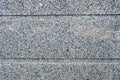 The texture of the stone wall is solid smooth of granite crumbs of two-color black and n horizontal stripes, lines. The background Royalty Free Stock Photo