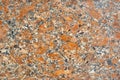 Texture - the surface of a granite slab with orange impregnations Royalty Free Stock Photo