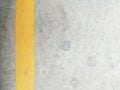 Texture surface of grey concrete road with scratches, indents and chipped with yellow lane divider line with copy space. Royalty Free Stock Photo