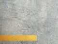 Texture surface of grey concrete road with scratches, indents and chipped with yellow lane divider line with copy space. Royalty Free Stock Photo