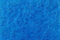 Texture of a surface of intertwined blue threads, abrasive of a synthetic fiber, abstract background