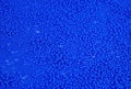 The texture of the surface of scattered blue beads for needlework