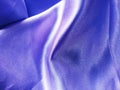 Texture and Surface of Wavy and Shiny Purple Silk Satin Fabric, Suitable for Background and Backdrop Use Royalty Free Stock Photo