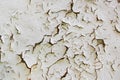 Texture of a thick layer of old white paint close-up on a metal surface. Vintage background